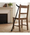 Canne de marche réglable noire orthopédique avec poignée ergonomique appuyée contre une chaise de salon.
