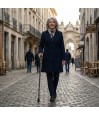 Femme marchant avec élégance et sécurité en ville grâce à sa canne de marche hirondelles.