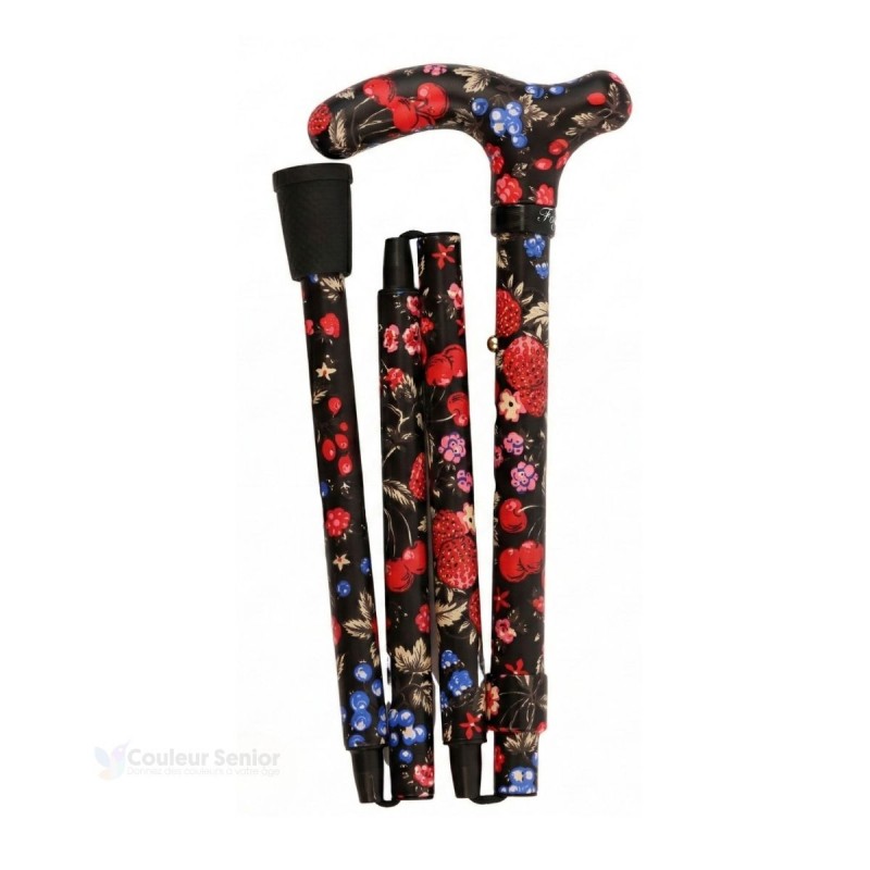 Canne de marche pliable pour femme, motif fruits rouges sur fond noir, pliée à gauche.