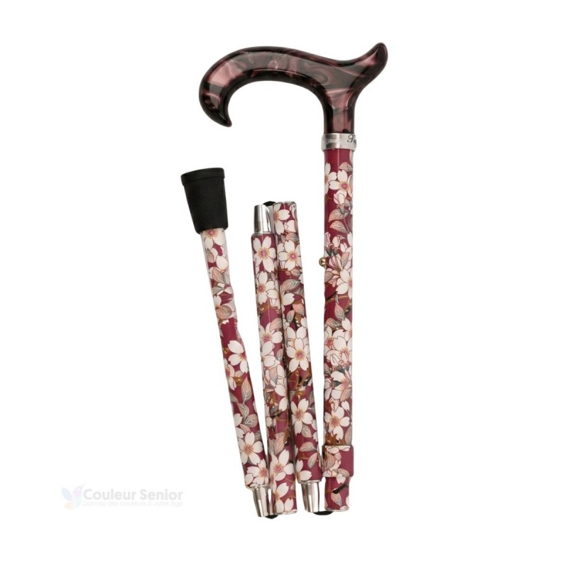 Canne de marche pliée vieux rose, discrète et élégante pour femme en aluminium léger.