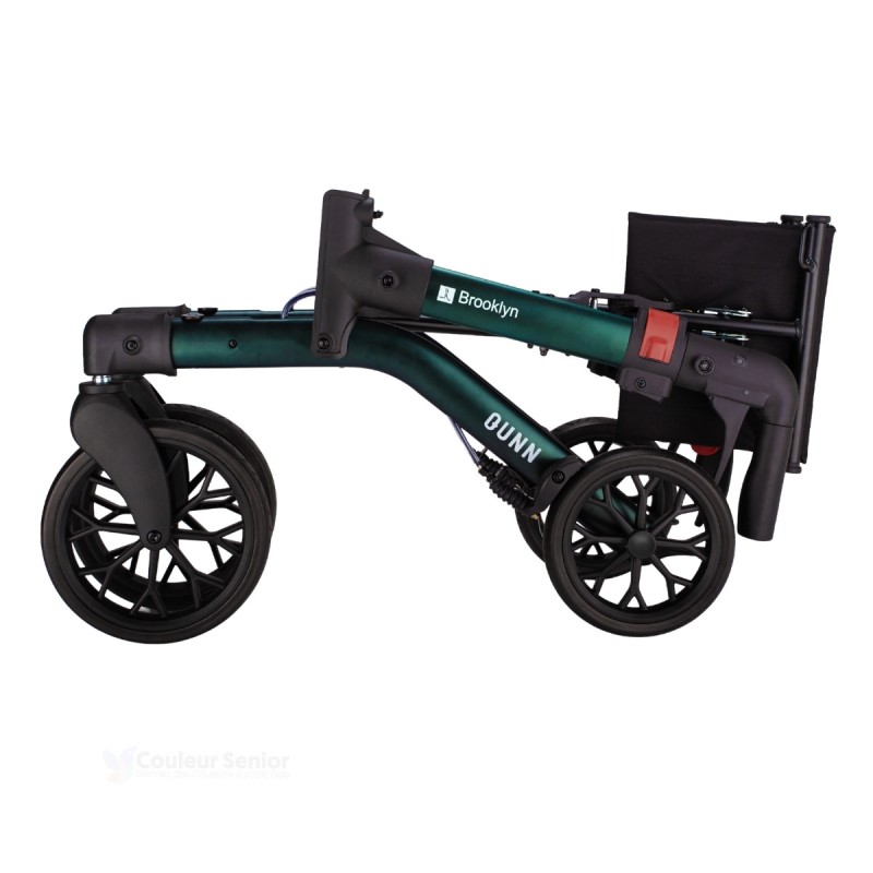 Déambulateur Brooklyn vert doublement plié, ultra-compact pour un transport en voiture aisé.