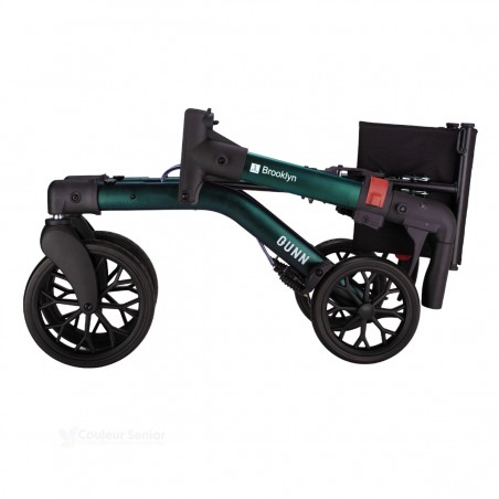 Déambulateur Brooklyn vert doublement plié, ultra-compact pour un transport en voiture aisé.