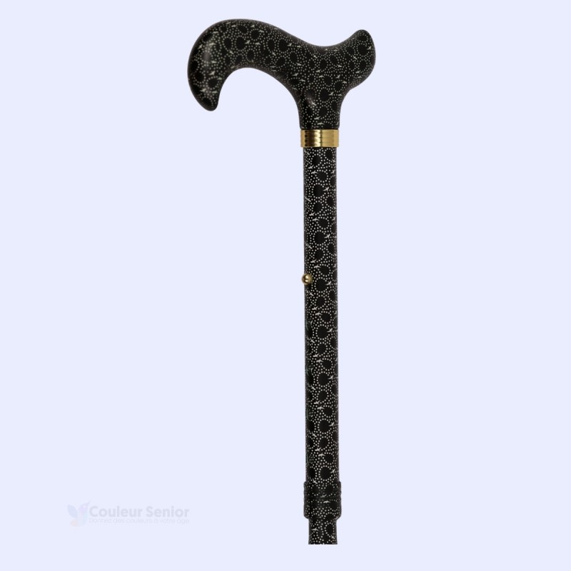 Canne senior pliable noire à petits motifs, vue à 45°. Accessoire original pour femme.