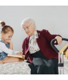 Grand-mere assise sur lit avec enfant tenant poignee aide au lever Let's Get Up Trust