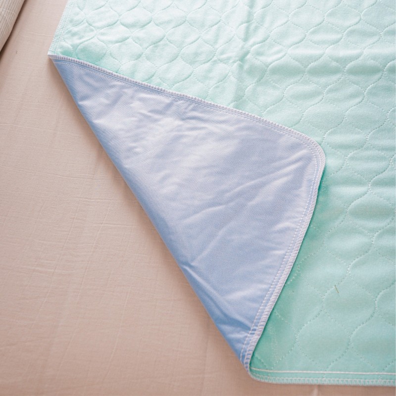Envers imperméable bleu d'une alèse lavable sans rabat – face antidérapante PVC