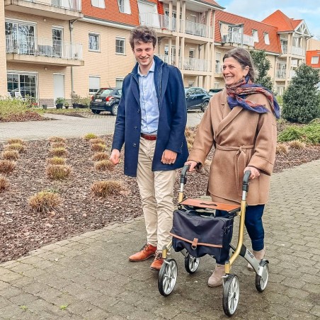 Senior se promenant en ville avec déambulateur Let's Go Out beige Trustcare sac inclus