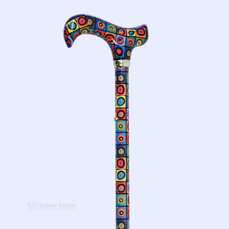 Angle de 45 degrés sur la poignée Derby à motifs de cercles et sur le collier doré.