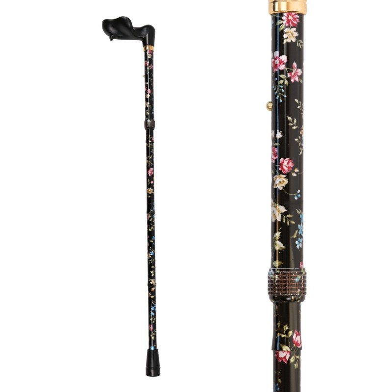 Vue complète magnifique canne de marche pour femme pliable anatomique, motif fleuri sur fond noir.