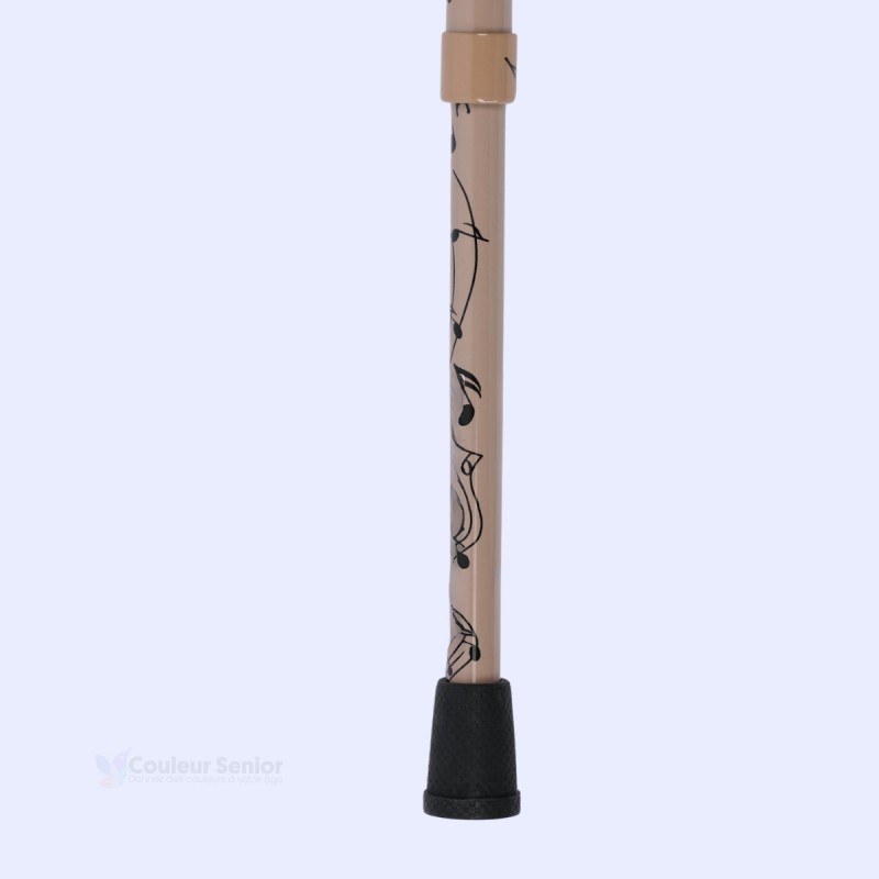 Détail embout antidérapant: canne de marche originale, motif musique, sobre, avec poignée T.