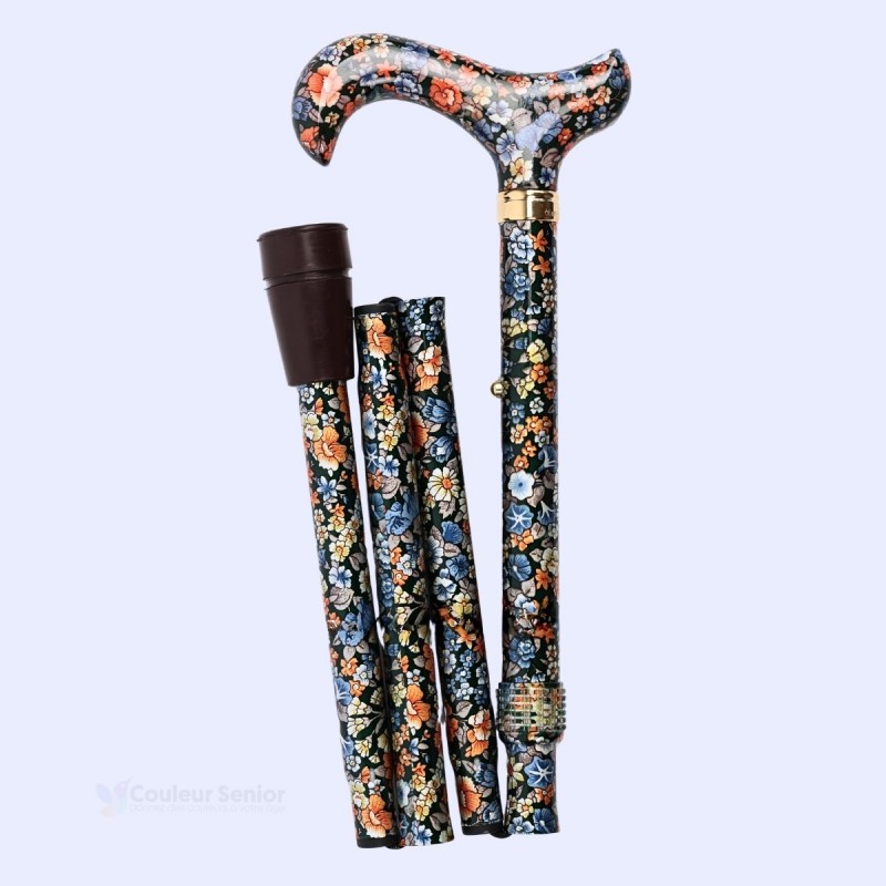Canne de marche pliante pour femme au motif floral vert, repliée en quatre sections compactes, vue du côté gauche.