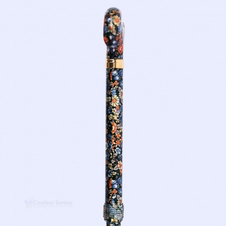 Détail du système de réglage en hauteur, avec bouton-poussoir et bague de serrage, sur le tube fleuri de la canne de marche.