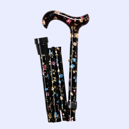 Canne pliante pour femme noire, pliée à gauche, motif floral assurant la sécurité à domicile.