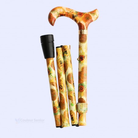 Canne pliante pour femme, à gauche, motif tournesols, assurant la sécurité à domicile.